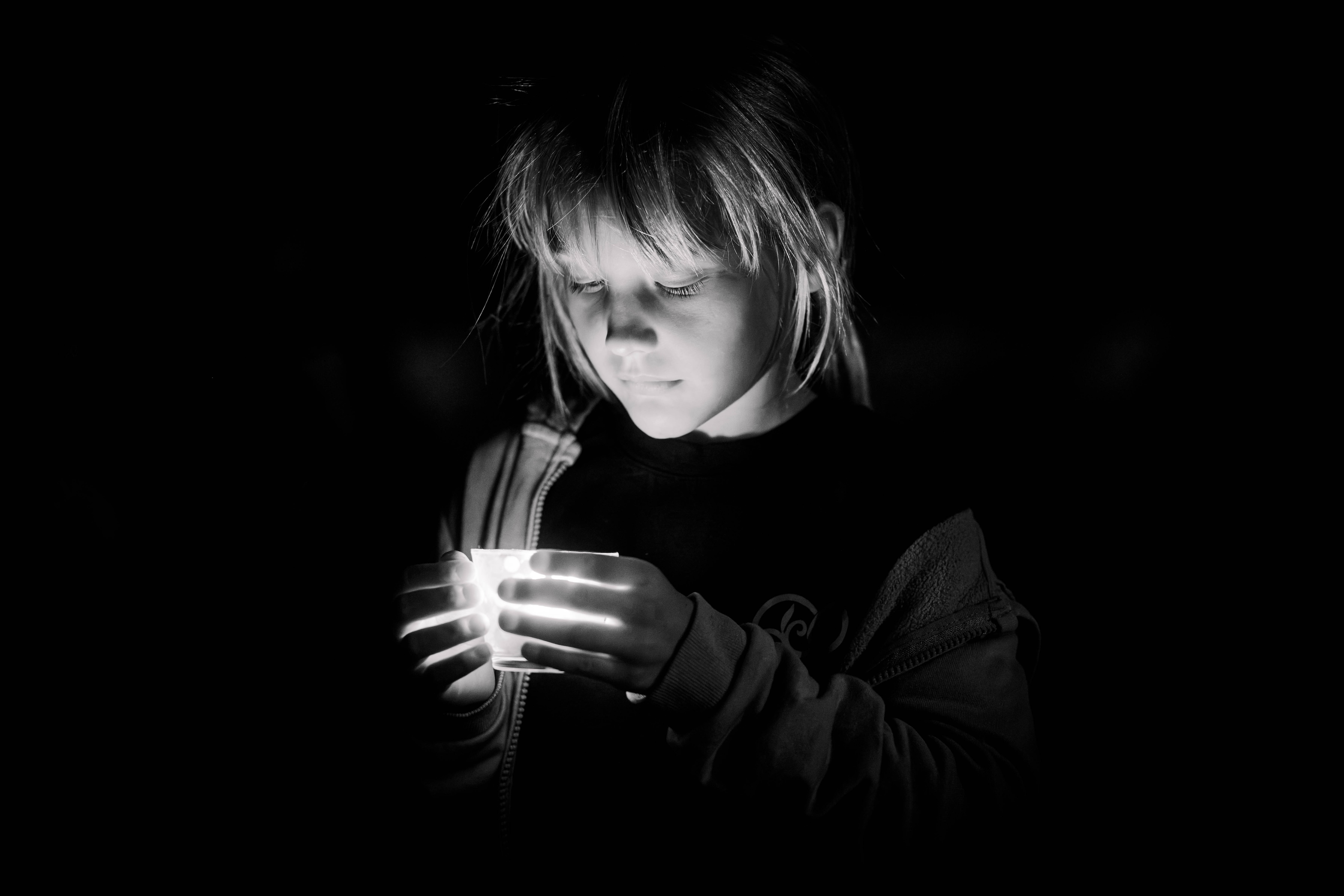 young girl praying with a candle