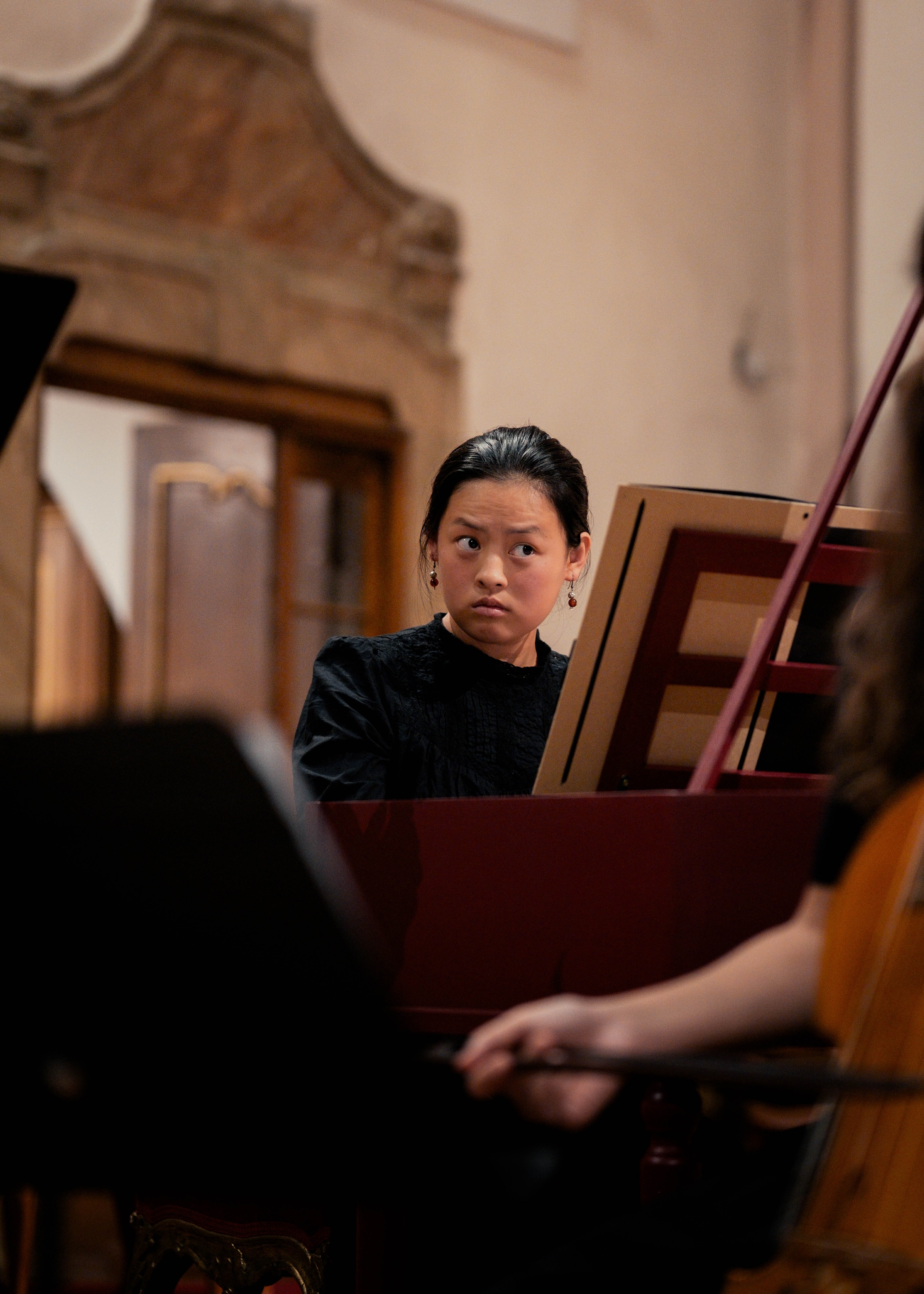musician playing harpsichord at baroque concert
