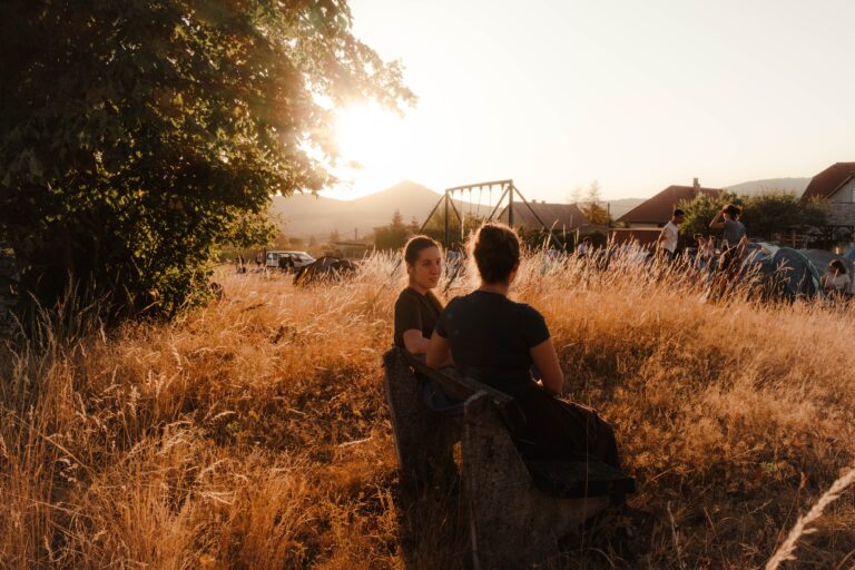 girls on park bench during the sunset